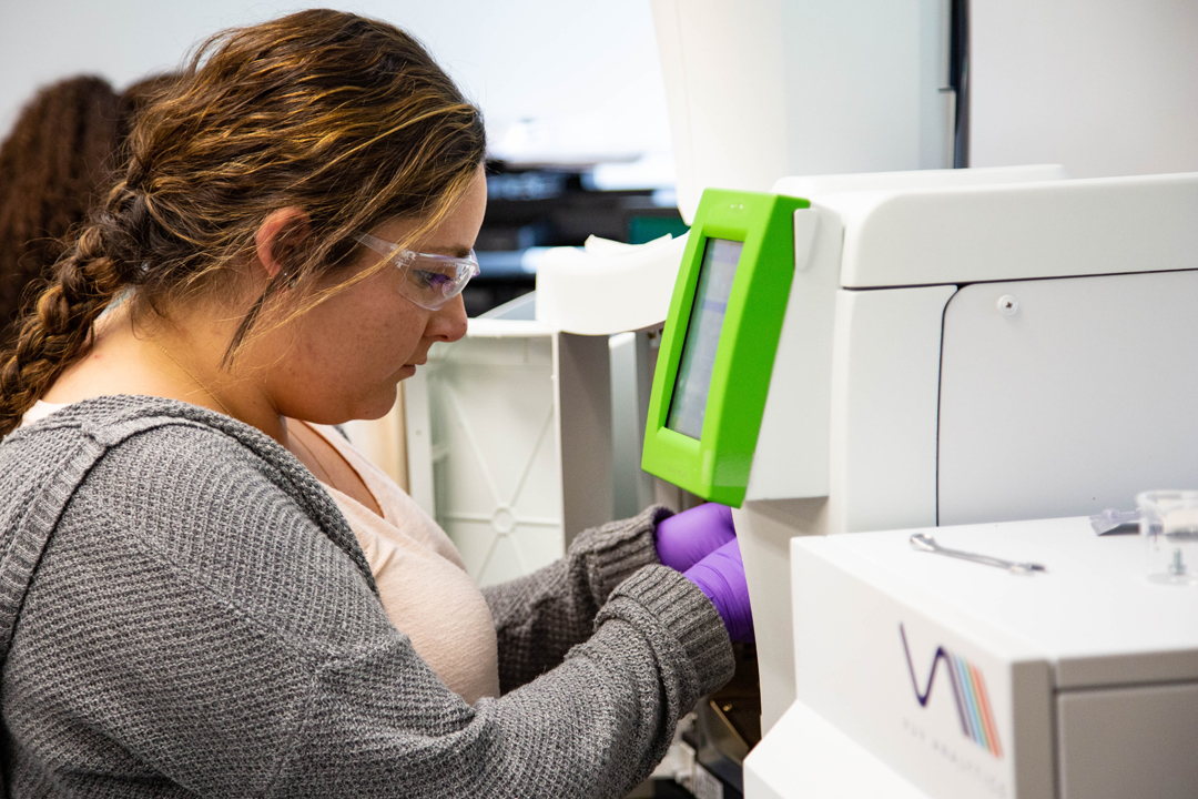 A woman using lab equipment.