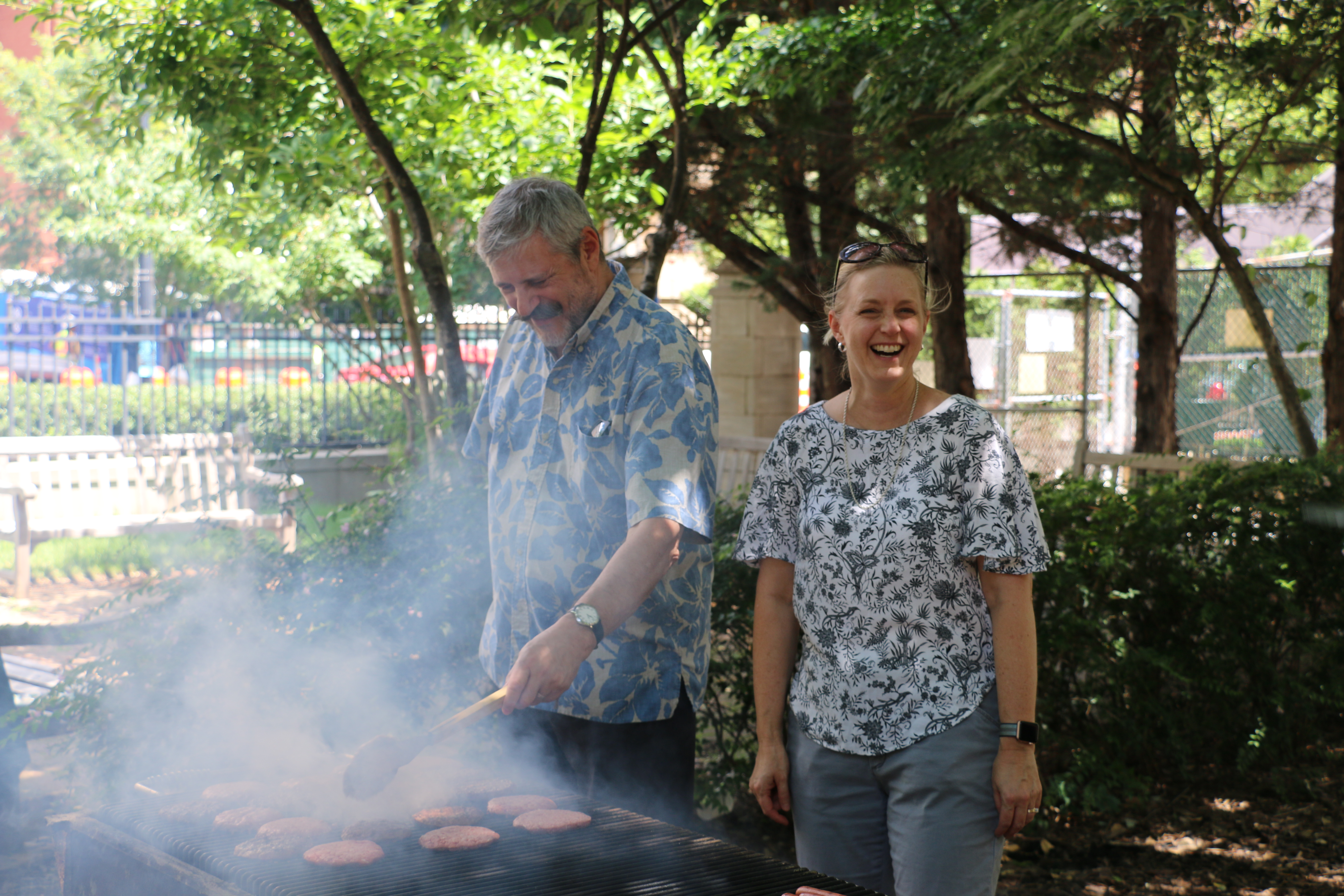 Drs. Vertes and Dowd having fun working the grill at a summer BBQ at GW