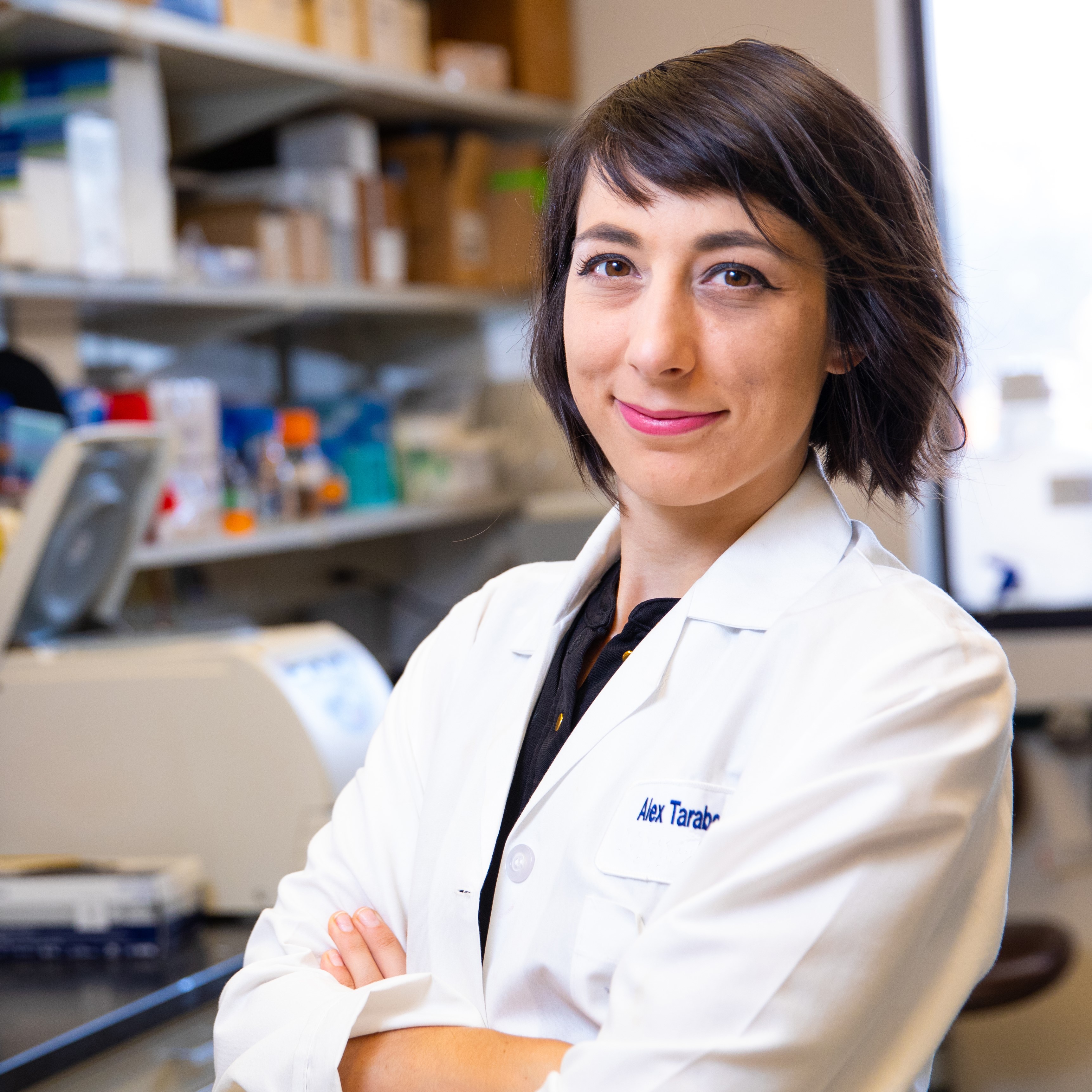 Dr. Taraboletti in a lab coat standing in her lab
