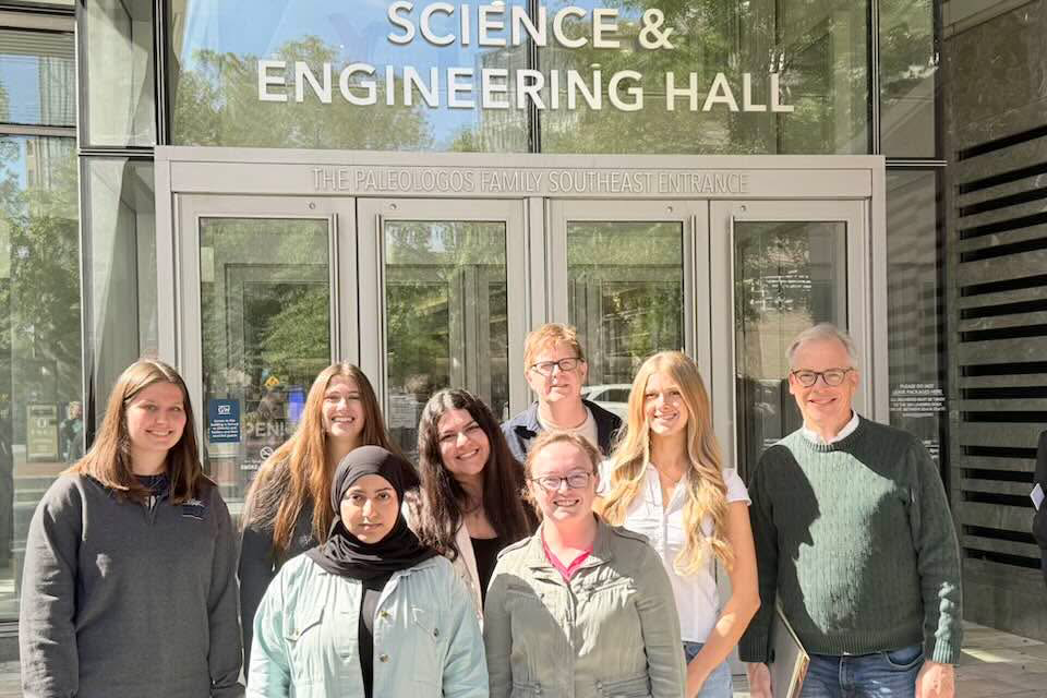 Cahill lab students smiling in front of Science and Engineering Hall