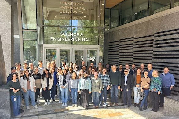 A large group of GW Chemistry faculty and students smiling outside the Science and Engineering Hall