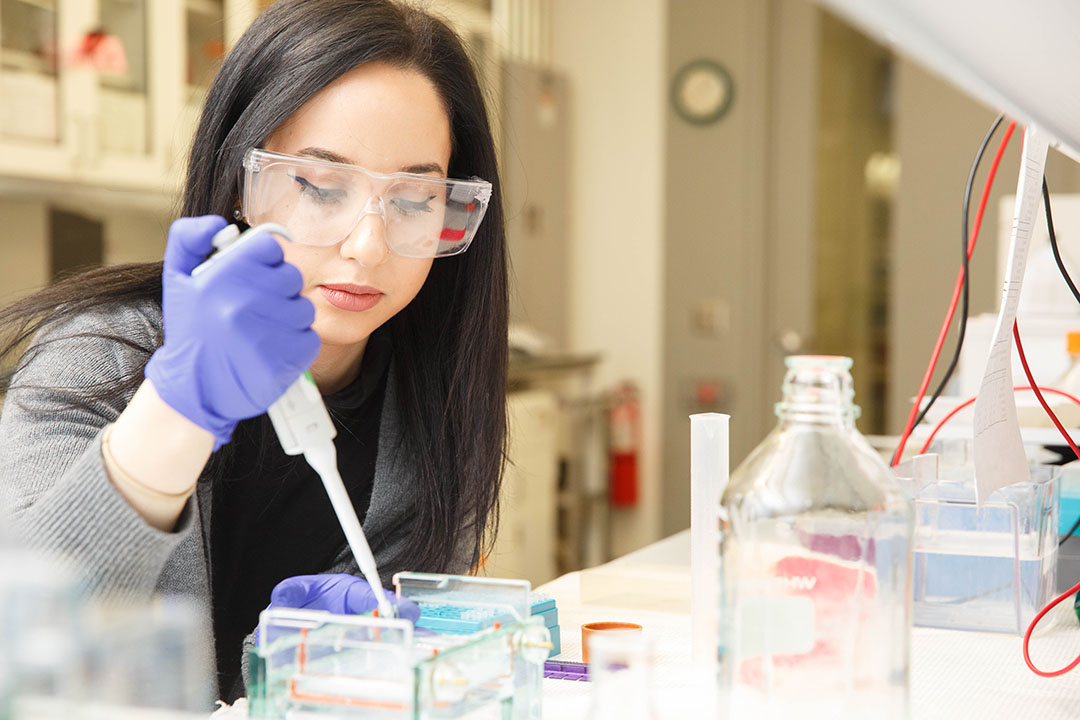 GW Chemistry student wearing goggles and gloves in a lab