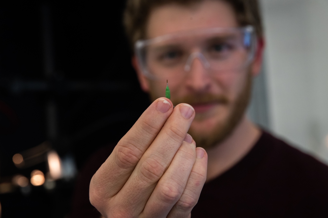 Chemistry Student holding an object