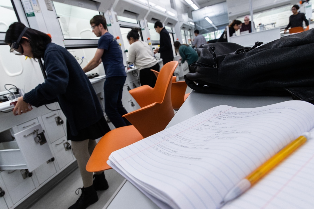 An open notebook on a table inside the GW Chemistry lab