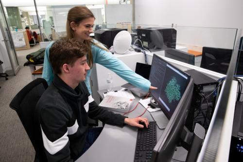 Students from Kostal's lab look at computer models