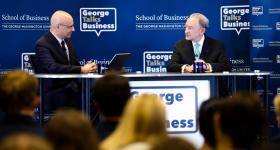 Mark Wrighton speaking on stage at a GW Business event