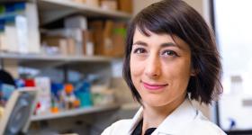 Dr. Taraboletti in a lab coat standing in her lab